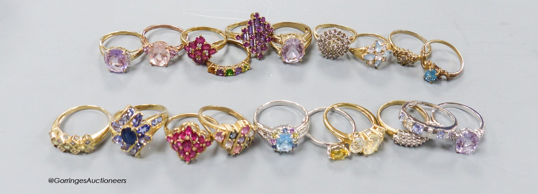 Twenty assorted modern 9ct or 9k and gem set dress rings, gross 59.1 grams.